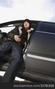 Caucasian male teenager sitting in SUV.
