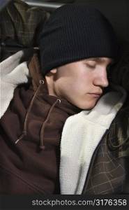Caucasian male teenager sleeping.