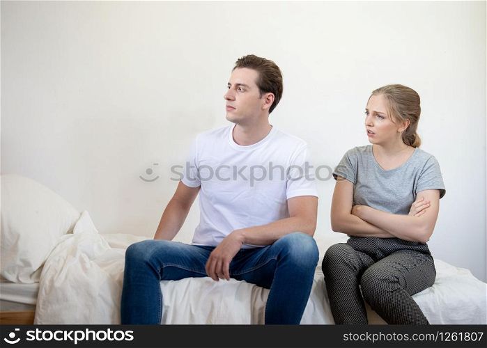 Caucasian man and woman have argument sit on bed in bedroom,Conflict violent and annoyed couple with unhappy relationship.