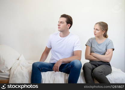 Caucasian man and woman have argument sit on bed in bedroom,Conflict violent and annoyed couple with unhappy relationship.