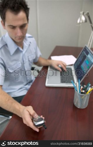 Caucasian Man Checking His Voicemail And Email At A Desk
