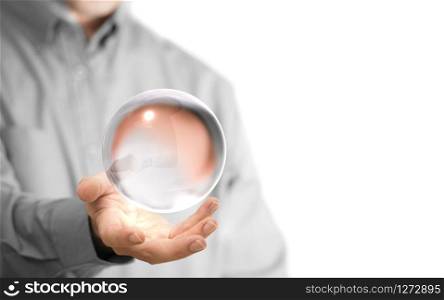 Caucasian man holding a glass or crystal ball, copy space on the left side of the image. Magician or fortuneteller background concept over white.. Crystal Ball