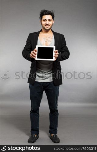 Caucasian man is standing with digital touch screen over grey background