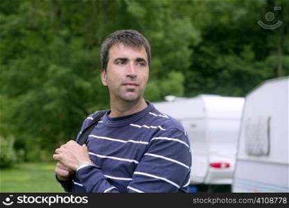 Caucasian man relaxed on the tent camping meadow