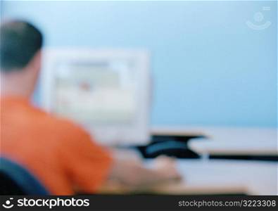 Caucasian Man Using A Desktop Computer In A Classroom