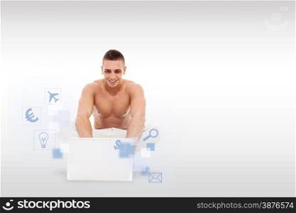 Caucasian man with nacked chest working with notebook on the floor over light grey background