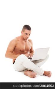 Caucasian man with naked chest working with notebook on the floor over white isolated background