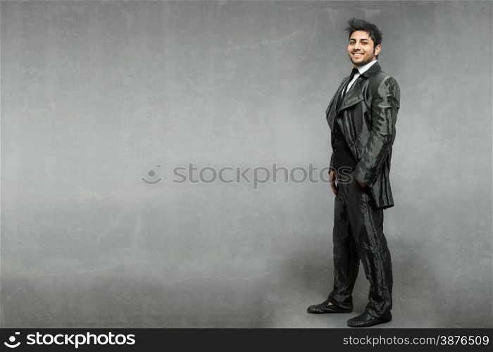 Caucasian man with shiny suit over grey background