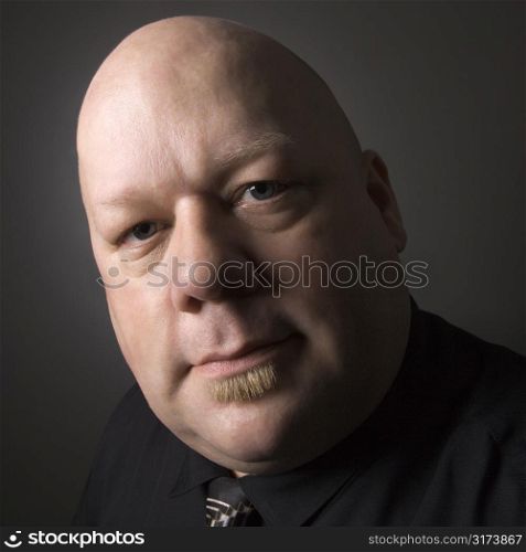 Caucasian mid adult bald man looking at viewer.