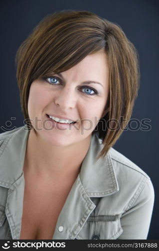 Caucasian mid adult brunette woman smiling at viewer.