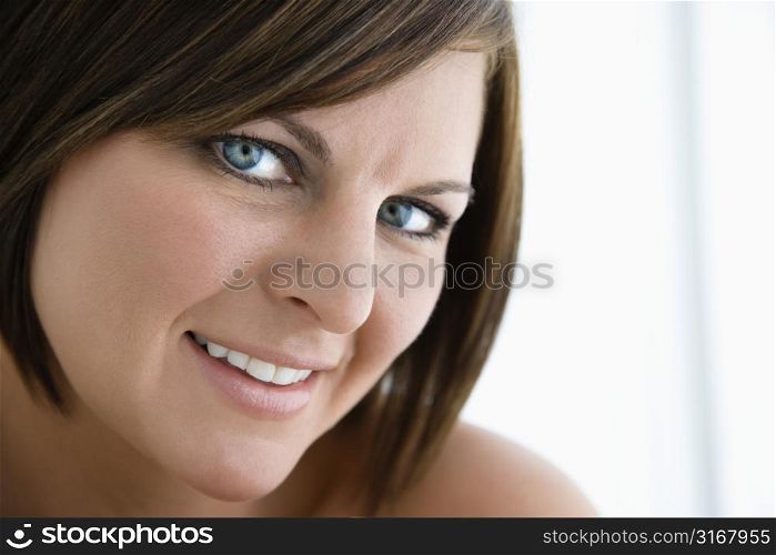 Caucasian mid adult brunette woman smiling at viewer.