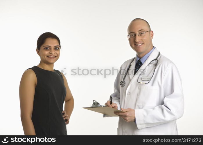 Caucasian mid adult male physician talking with Indian woman patient.