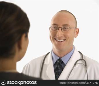 Caucasian mid adult male physician talking with Indian woman patient.