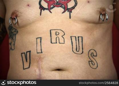 Caucasian mid-adult man midriff with tattoos and piercings.