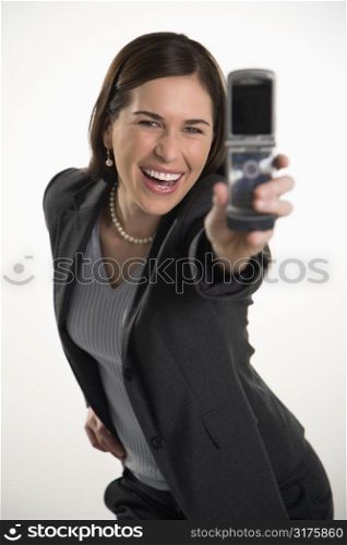 Caucasian mid adult professional business woman taking picture of self with camera phone and smiling.