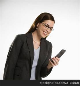 Caucasian mid adult professional business woman text messaging on cell phone.