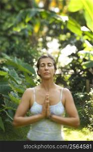 Caucasian mid-adult woman meditating.