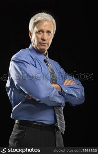 Caucasian middle aged businessman looking at viewer with arms crossed.