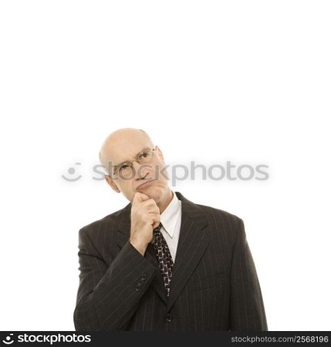 Caucasian middle-aged businessman looking thoughtful standing against white background.