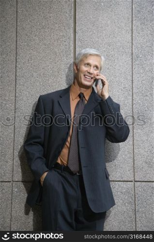 Caucasian middle aged businessman on cell phone smiling.
