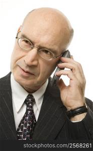Caucasian middle-aged businessman on cellphone against white background.