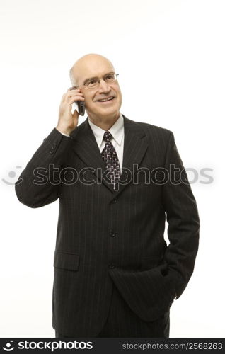 Caucasian middle-aged businessman talking on cellphone against white background.