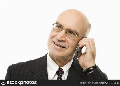 Caucasian middle-aged businessman talking on cellphone smiling against white background.