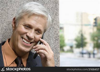Caucasian middle aged businessman talking on phone.