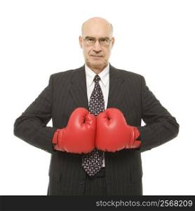 Caucasian middle-aged businessman wearing boxing gloves.