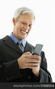 Caucasian middle aged man smiling and text messaging on cell phone.