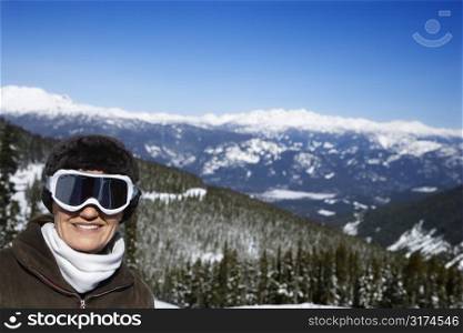 Caucasian middle-aged woman skier posing on mountain.