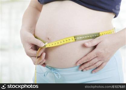 caucasian pregnant woman belly close up