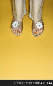 Caucasian prime adult female feet in open toed flower sandals.