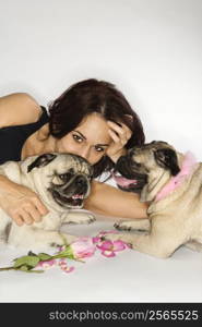 Caucasian prime adult female with two Pug dogs.