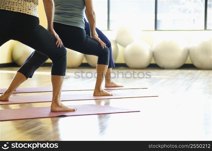 Caucasian prime adult females in yoga class.