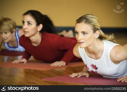 Caucasian prime adult females in yoga class.