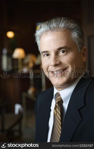 Caucasian prime adult male businessman in hotel lobby.