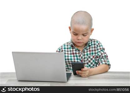 Caucasian school-age boy in a plaid shirt on a light isolated background playing games on the phone and at the same time on . modern children, their interests