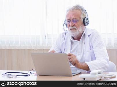 Caucasian senior doctor wearing headset and making online video conference to giving advice to patient with copy space. Medical and Technology concept.