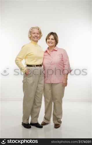 Caucasian senior woman and middle aged woman standing together.