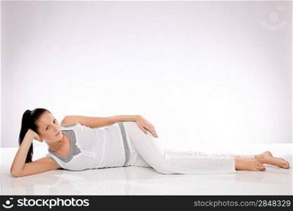 Caucasian slim young woman lying on the floor after exercises
