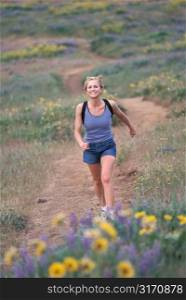 Caucasian Woman Hiking Through A Mountain Meadow