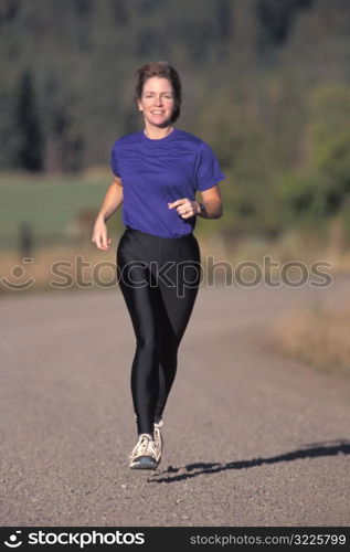 Caucasian Woman Jogging Along A Country Road
