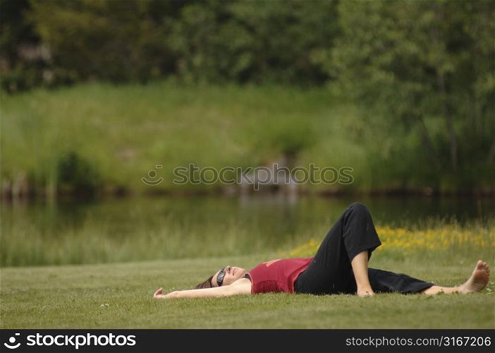 Caucasian woman laying on the grass