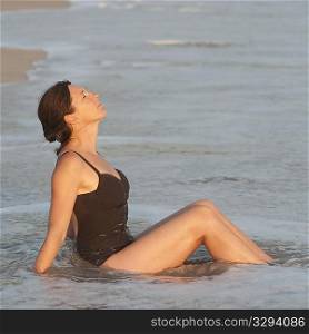 Caucasian woman relaxing in the water along Costa Rica shoreline