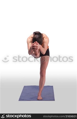 Caucasian Woman Stretching On A Blue Yoga Mat