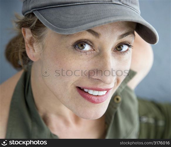 Caucasian woman wearing hat smiling at viewer.