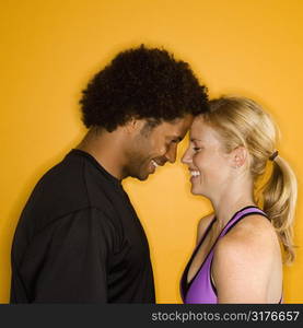 Caucasian woman with head against African-American male&acute;s head.