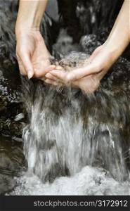 Caucasian young adult female hands washing in pure clean fresh water.