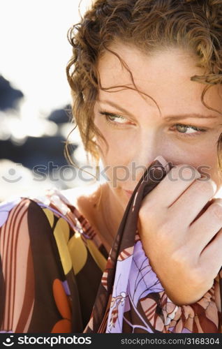 Caucasian young adult female looking off with serious expression.